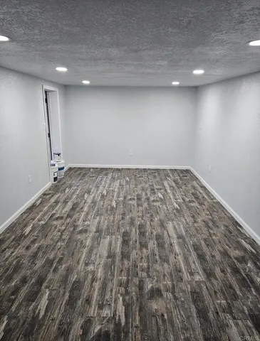 a view of a room with wooden floor and window