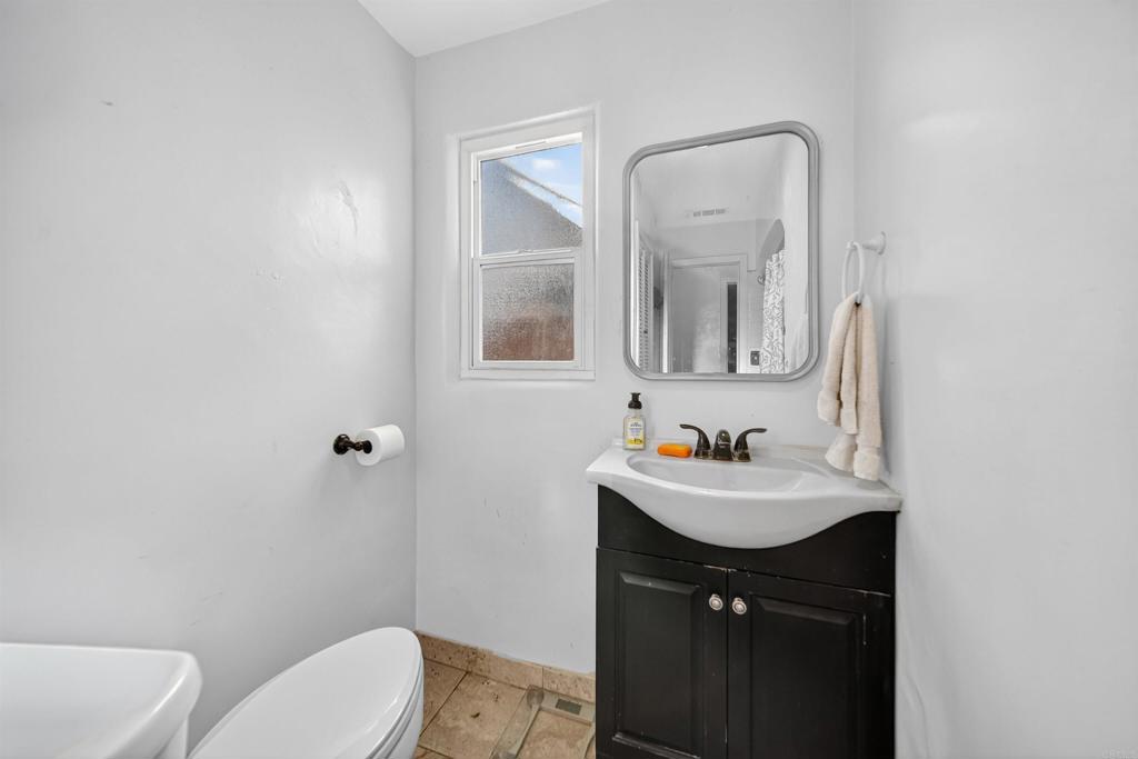 2126 Tulare Street Selma, CA 93662 - Photo 33 of 40 a bathroom with a toilet sink and mirror