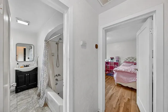 a bedroom with two beds and painting on the wall