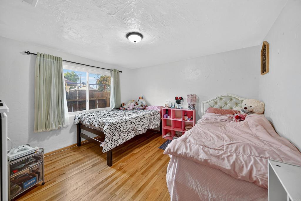 2126 Tulare Street Selma, CA 93662 - Photo 37 of 40 a bedroom with two beds and painting on the wall