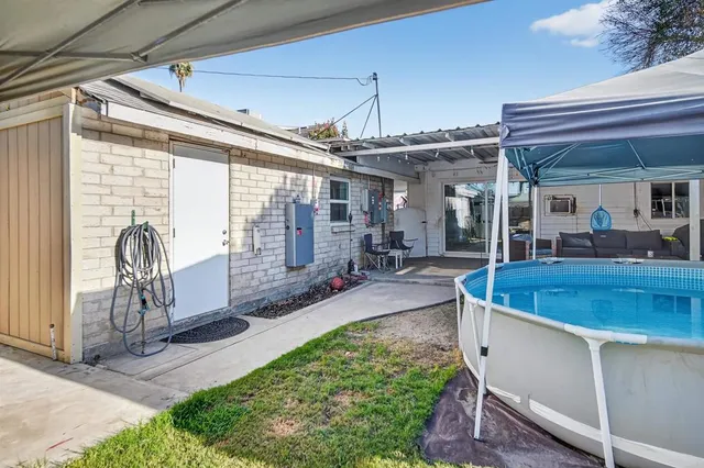 an aerial view of residential houses with outdoor space and trees