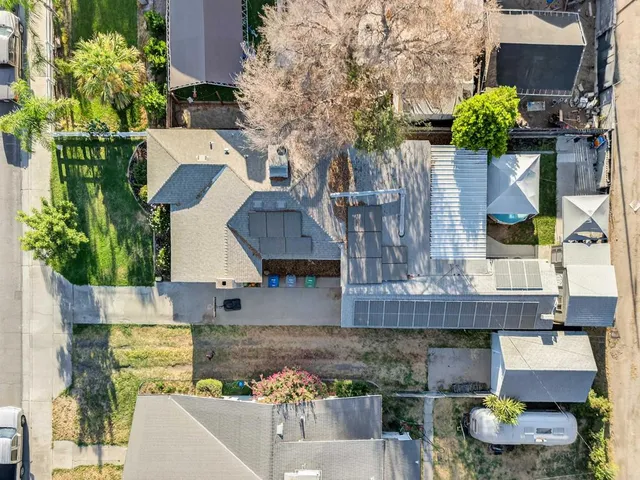 a aerial view of a house with large trees