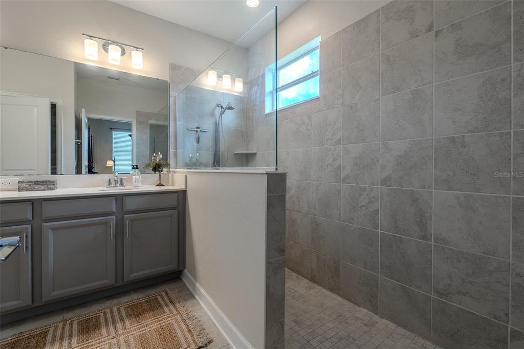 9224 Southwest 60th Ct Road Ocala, FL 34476 - Photo 30 of 55 a bathroom with a sink shower and a mirror