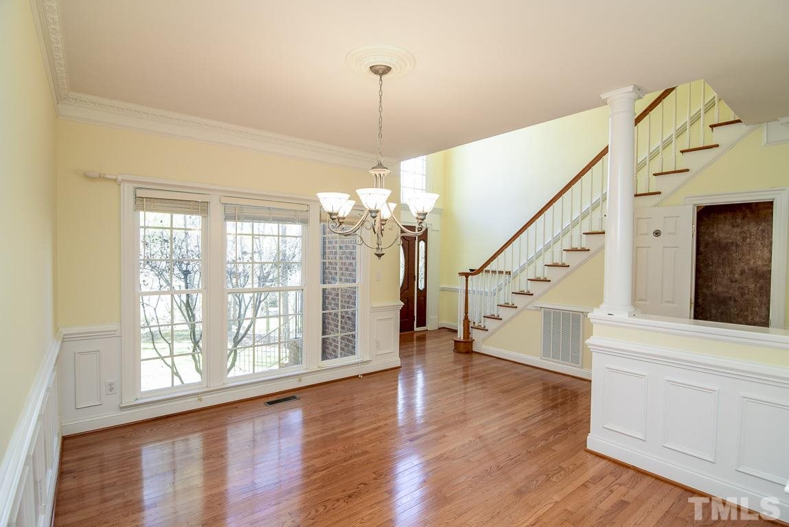 Beautiful formal dining room with hardwoods. Although it is a separate area it is open and flows into the kitchen and family room. There is extensive gingerbread molding in this room.