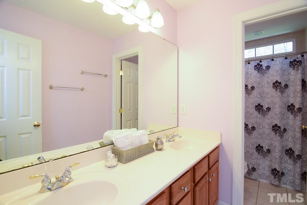 3813 April Place Raleigh, NC 27612 - Photo 22 of 25 secondary bathroom with ceramic tile and double vanity.