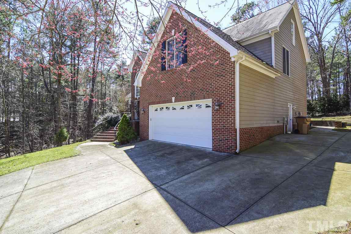 3813 April Place Raleigh, NC 27612 - Photo 24 of 25 2 car garage with a a side parking pad.