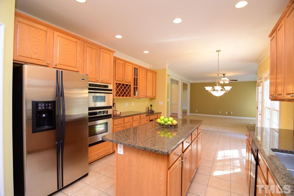 Double oven and bill pay counter with storage for wine. Also a large granite top island to serve your buffet. Kitchen flows right into the family room.