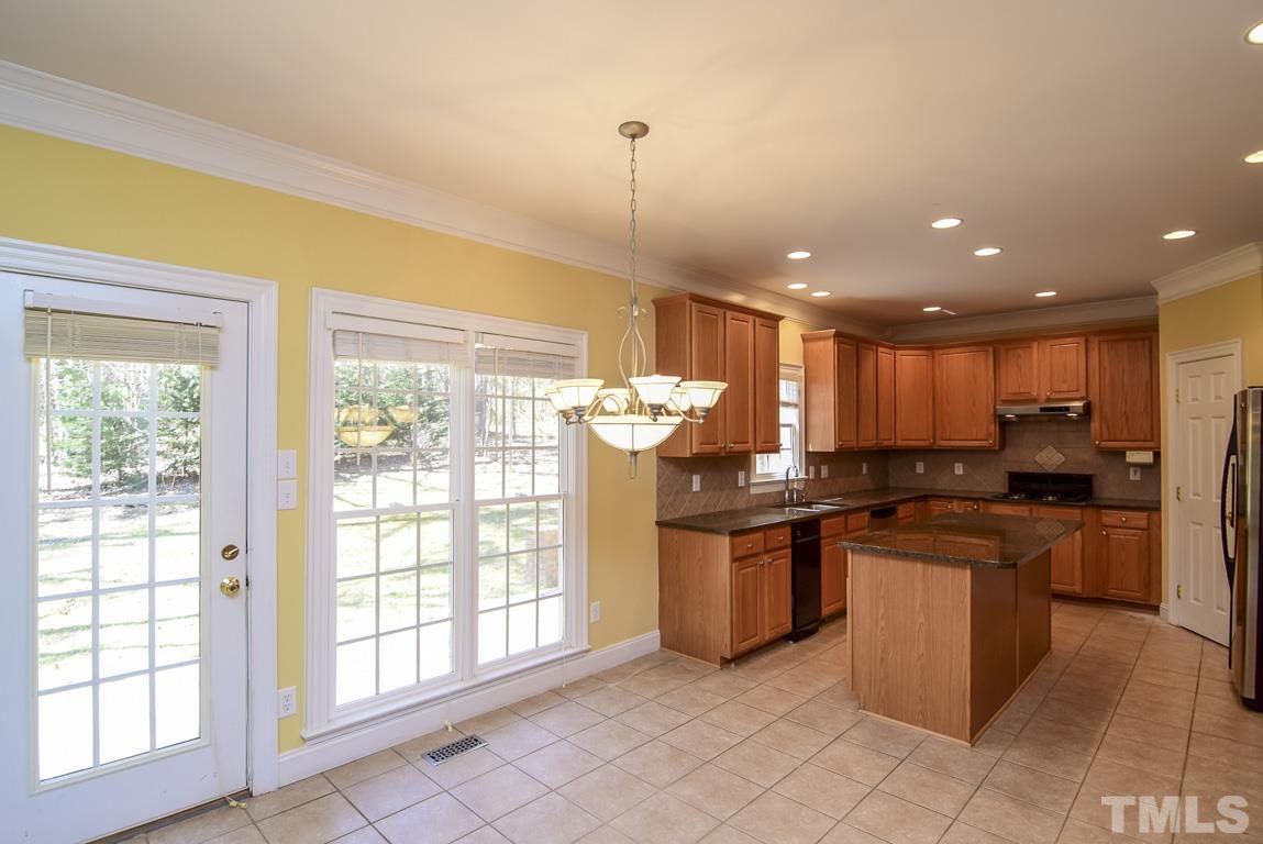 The breakfast area is quite large, and would fit a big table. It looks out at the large backyard.