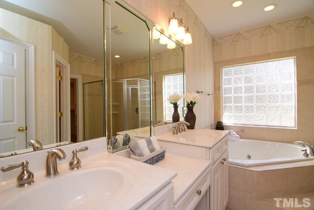 3813 April Place Raleigh, NC 27612 - Photo 9 of 25 The master bath is bright and light.