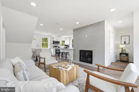 a living room with furniture a fireplace and a table