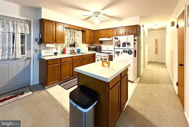a kitchen with a refrigerator a sink and cabinets