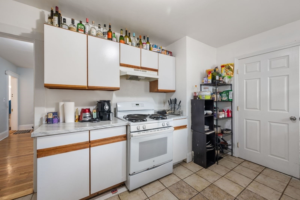 18 Claymoss Road, Unit 1 Boston, MA 02135 - Photo 1 of 24 a kitchen with stainless steel appliances granite countertop a stove and cabinets