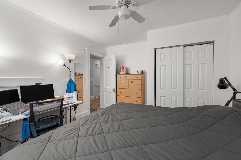 18 Claymoss Road, Unit 1 Boston, MA 02135 - Photo 14 of 24 a bedroom with a bed and a chandelier