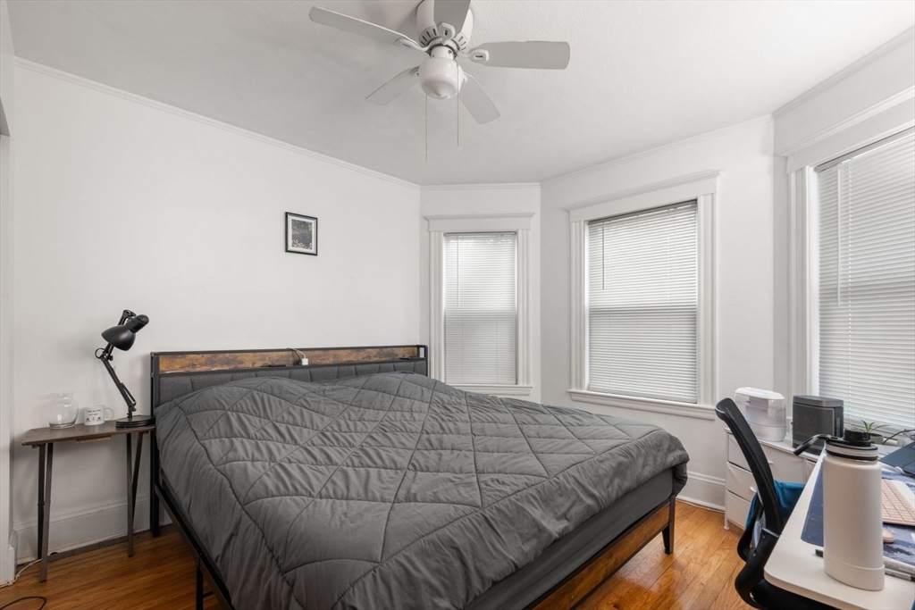 18 Claymoss Road, Unit 1 Boston, MA 02135 - Photo 15 of 24 a bedroom with a bed and a desk