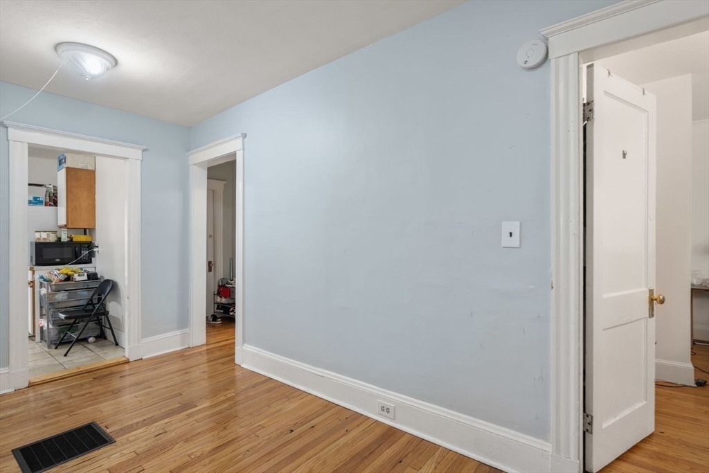 18 Claymoss Road, Unit 1 Boston, MA 02135 - Photo 17 of 24 a view of a hallway with wooden floor and a living room