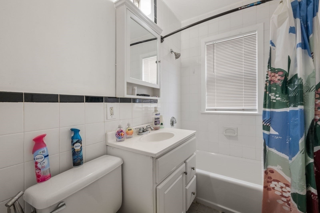 18 Claymoss Road, Unit 1 Boston, MA 02135 - Photo 20 of 24 a bathroom with a sink toilet vanity and tub