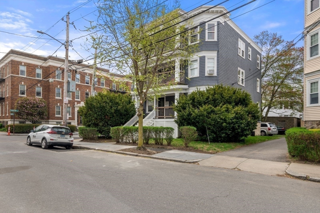 18 Claymoss Road, Unit 1 Boston, MA 02135 - Photo 22 of 24 a car parked in front of a brick building
