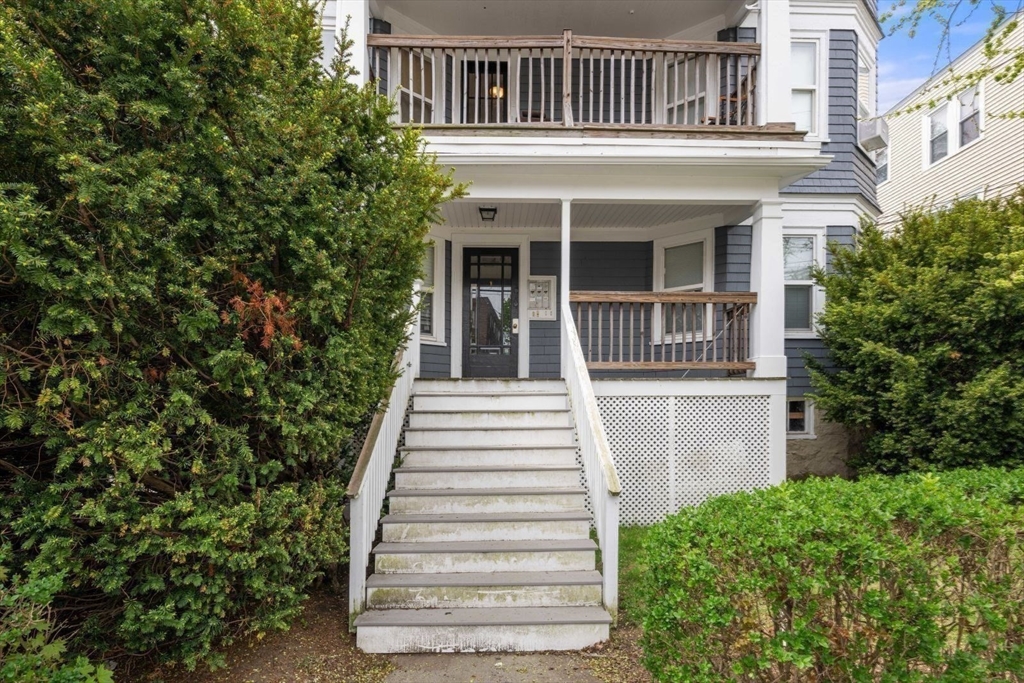 18 Claymoss Road, Unit 1 Boston, MA 02135 - Photo 23 of 24 a front view of a house with a garden
