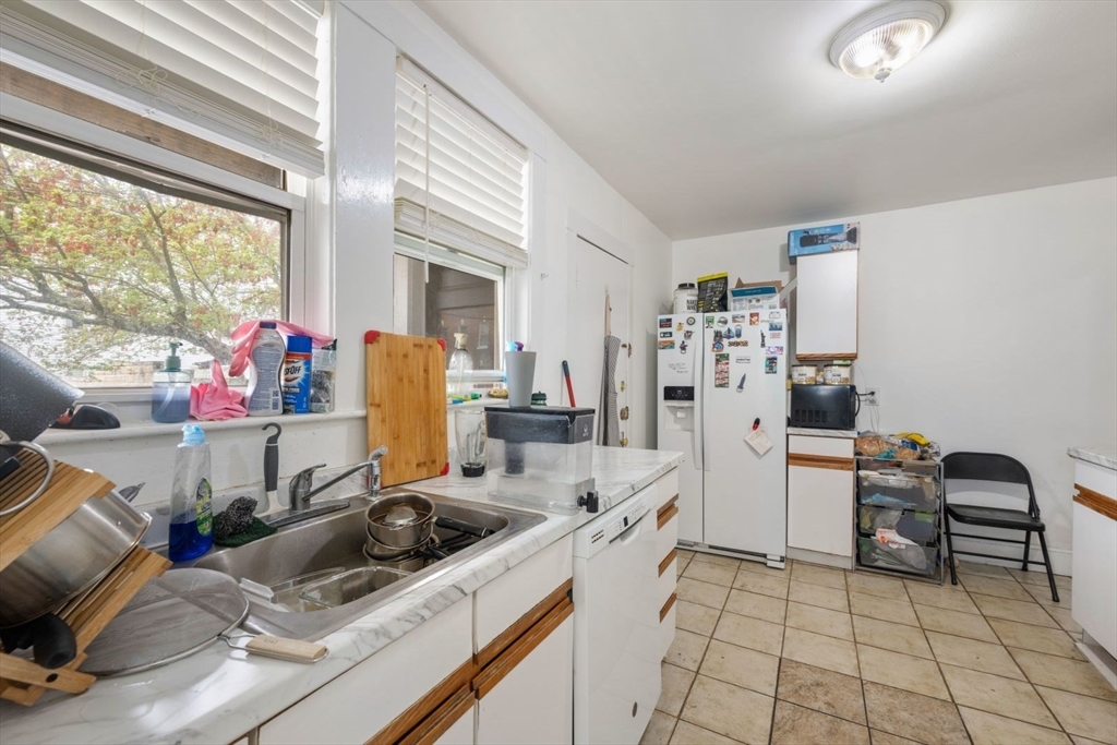 18 Claymoss Road, Unit 1 Boston, MA 02135 - Photo 3 of 24 a room with furniture a flat screen tv and a window