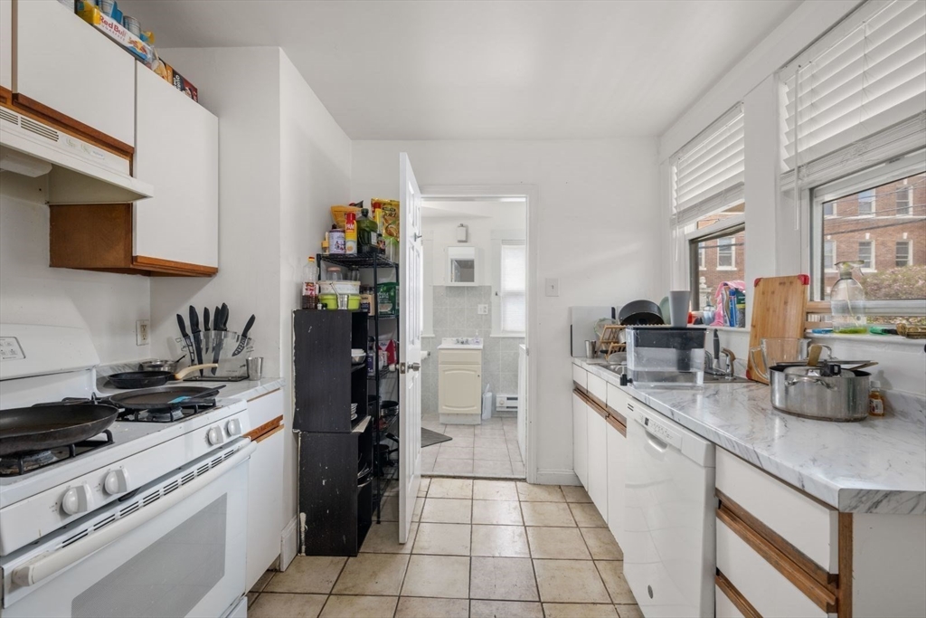 18 Claymoss Road, Unit 1 Boston, MA 02135 - Photo 4 of 24 a kitchen with a sink cabinets and appliances