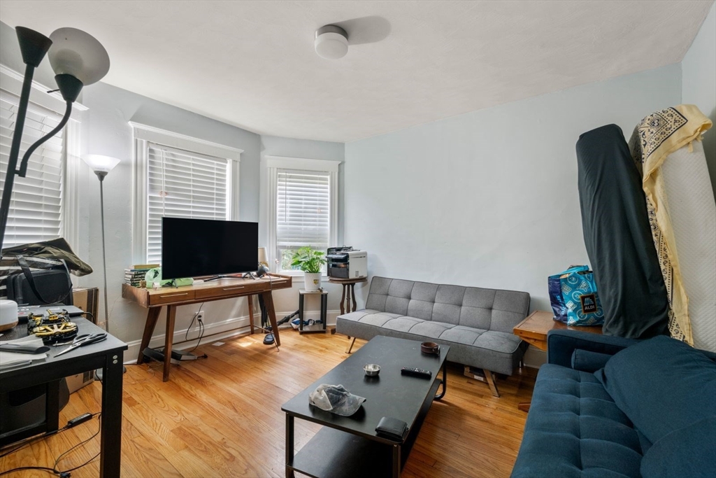 18 Claymoss Road, Unit 1 Boston, MA 02135 - Photo 6 of 24 a living room with furniture and a flat screen tv