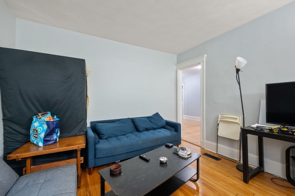 18 Claymoss Road, Unit 1 Boston, MA 02135 - Photo 7 of 24 a living room with furniture and a flat screen tv