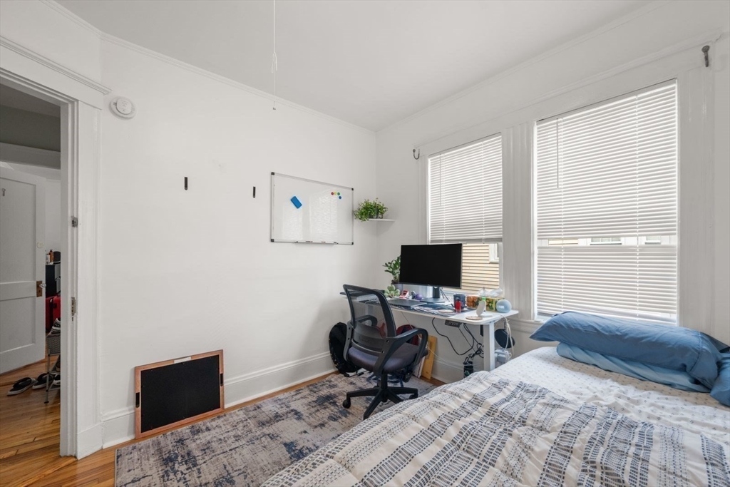 18 Claymoss Road, Unit 1 Boston, MA 02135 - Photo 8 of 24 a bedroom with a bed and a window