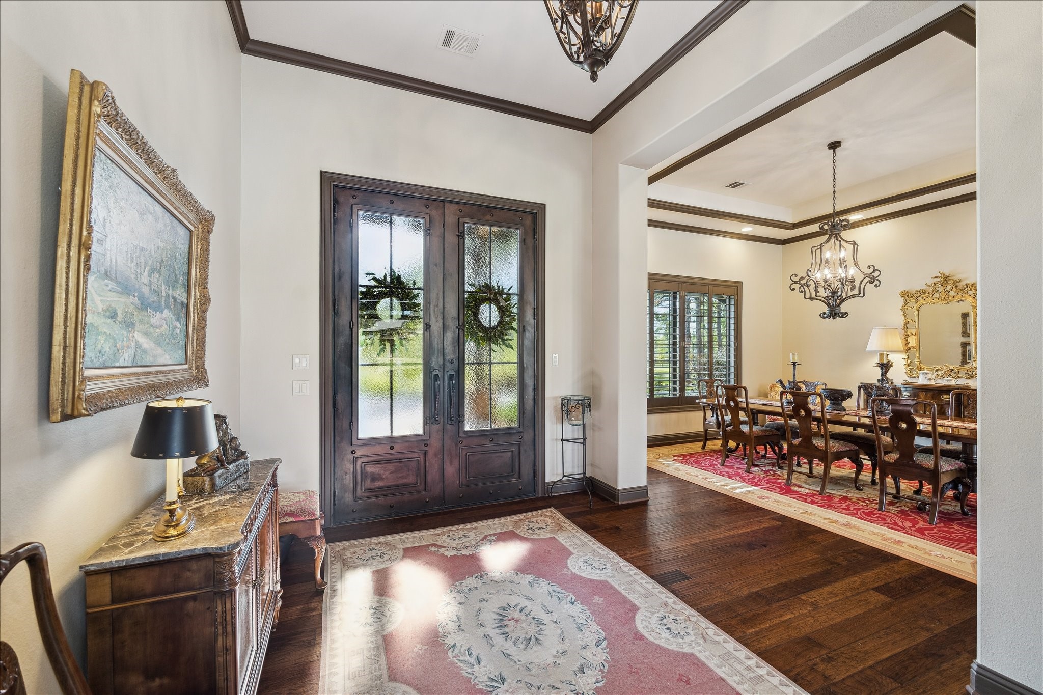 11 Willowcreek Ranch Road Tomball, TX 77377 - Photo 16 of 49 Double custom steel and glass doors welcome guests to this custom one story ranch. Rich hardwood flooring flows throughout and creates a continuity between spaces and a warmth that contrasts with the neutral wall color.