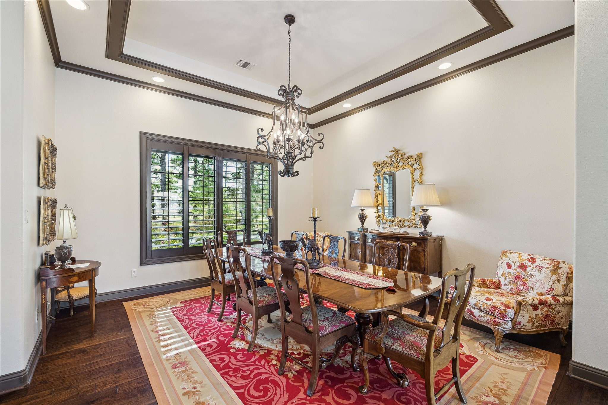 11 Willowcreek Ranch Road Tomball, TX 77377 - Photo 17 of 49 The dining room features large windows overlooking the estate, plantation shutters, a tray ceiling with crown molding and custom wrought iron chandelier.