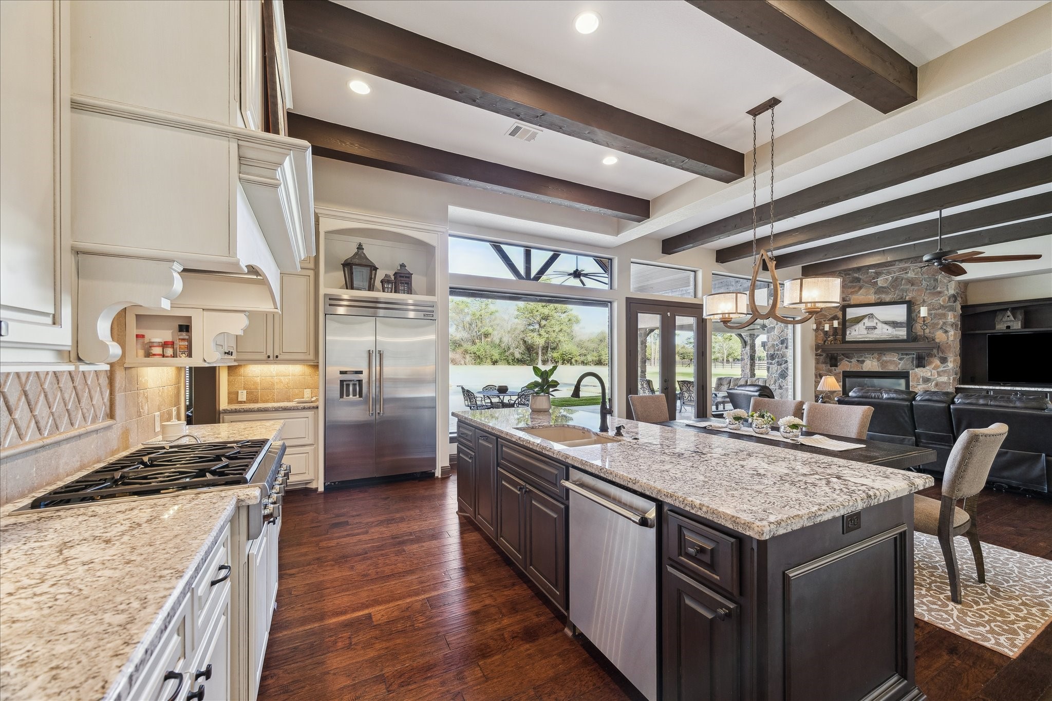 11 Willowcreek Ranch Road Tomball, TX 77377 - Photo 22 of 49 The kitchen features Thermador appliances including the built in refrigerator, six burner gas cooktop and built in ventilation, double ovens, microwave and warming drawer.