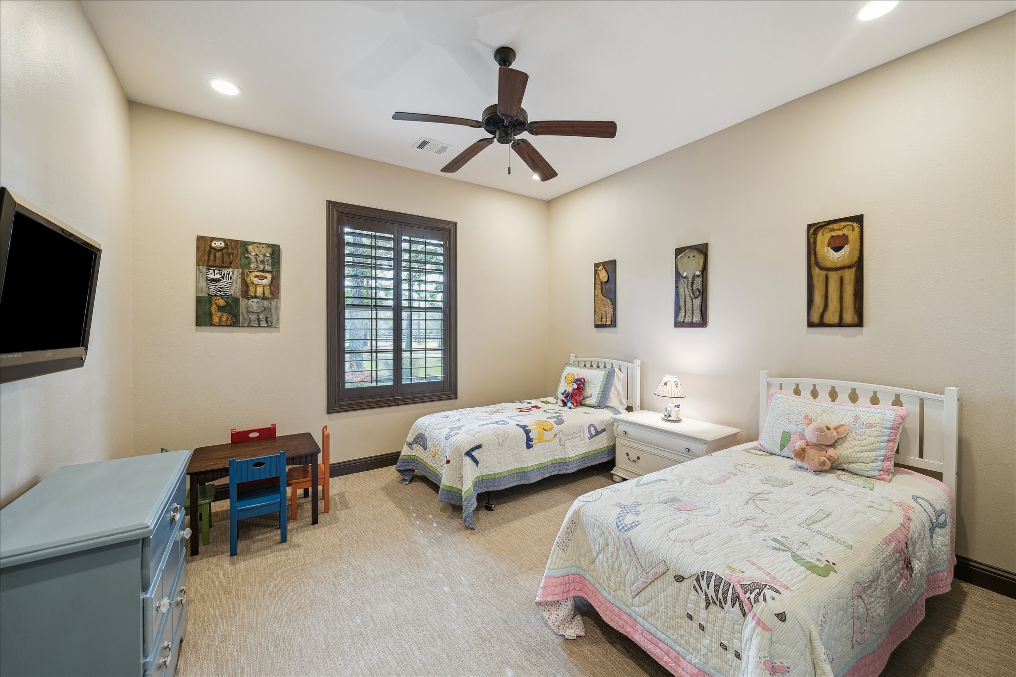 11 Willowcreek Ranch Road Tomball, TX 77377 - Photo 32 of 48 a bedroom with two beds and a chandelier