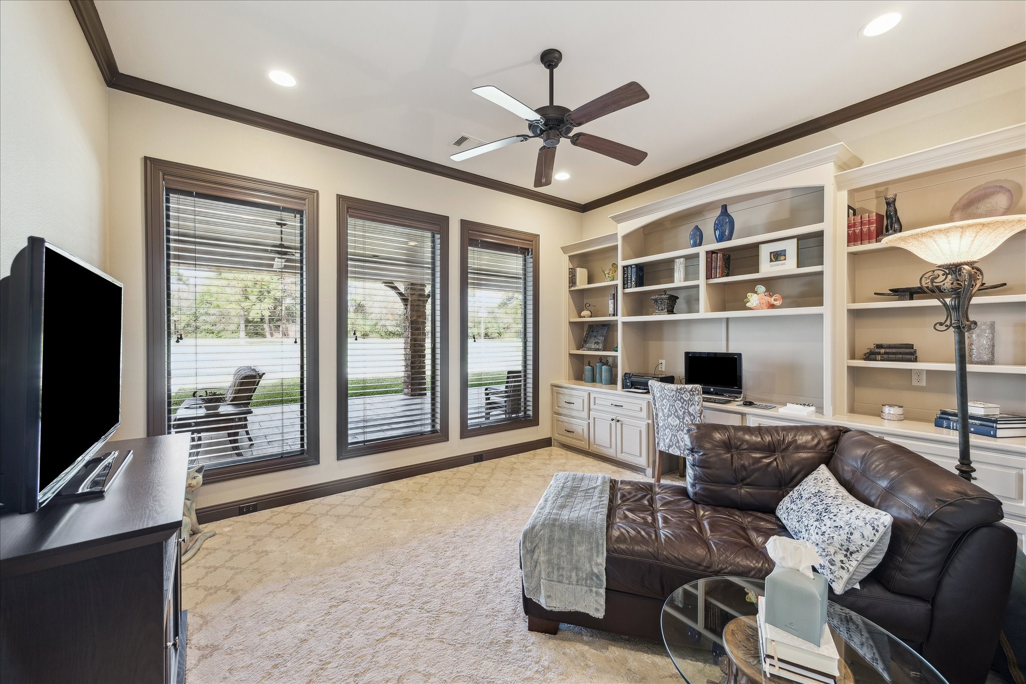11 Willowcreek Ranch Road Tomball, TX 77377 - Photo 44 of 49 Another one of two offices featured in this home. This office features a wall of built-in cabinets, drawers, desks and shelves. It also features a wall of windows.