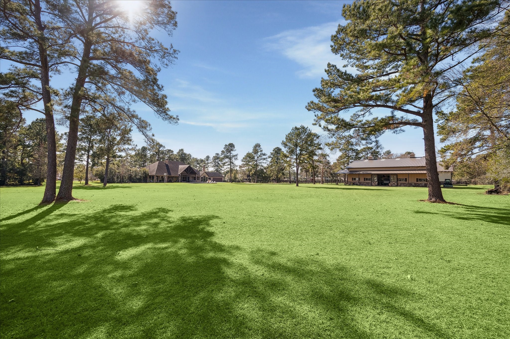 11 Willowcreek Ranch Road Tomball, TX 77377 - Photo 47 of 49 An open grassy pasture allows for endless possibilities. It could be enclosed for horses and equipped for play! The property enjoys a Rainsoft water softening system, PEX plumbing, 2026 Generac generator, and a 5HP well that pumps 50g/min. The well feeds the pond (if desired), the entire irrigation system, pool and barn!