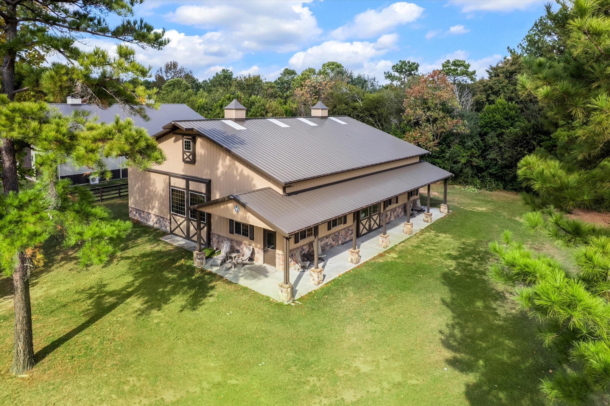 11 Willowcreek Ranch Road Tomball, TX 77377 - Photo 7 of 49 The Morton built barn features a standing seam metal roof, stone accents and cedar posts. Two charming weathervanes finish the look.