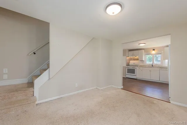 a view of a room with kitchen and windows