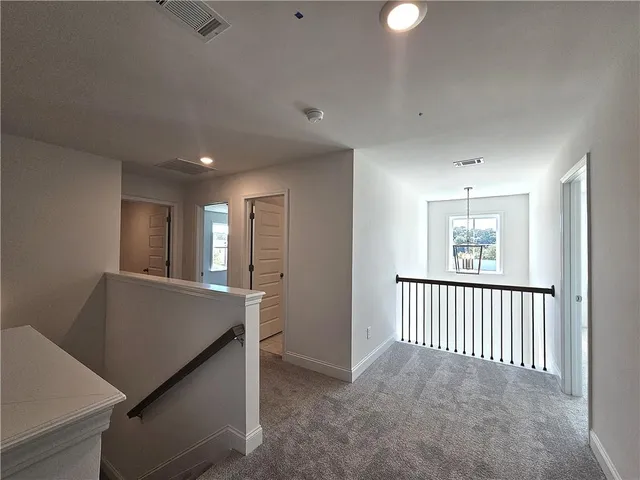 a view of a livingroom with a ceiling fan window and a chandelier