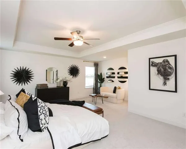 an empty room with windows and ceiling fan