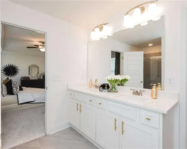 a bathroom with a granite countertop sink and shower