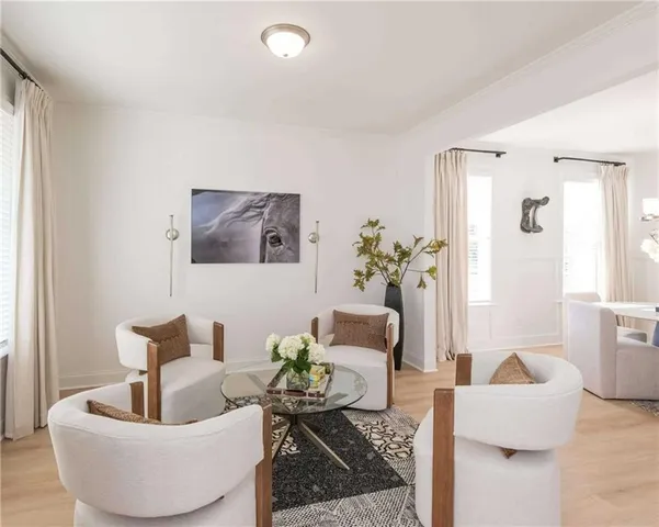 a living room with furniture and a potted plant