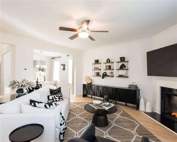 a living room with furniture a fireplace and a flat screen tv