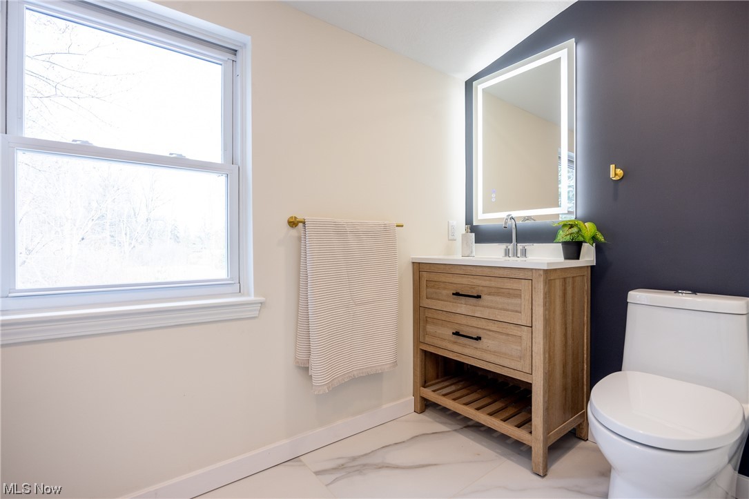 32887 Cedar Road Mayfield Heights, OH 44124 - Photo 33 of 44 Bathroom featuring vanity, toilet, vaulted ceiling, and tile flooring