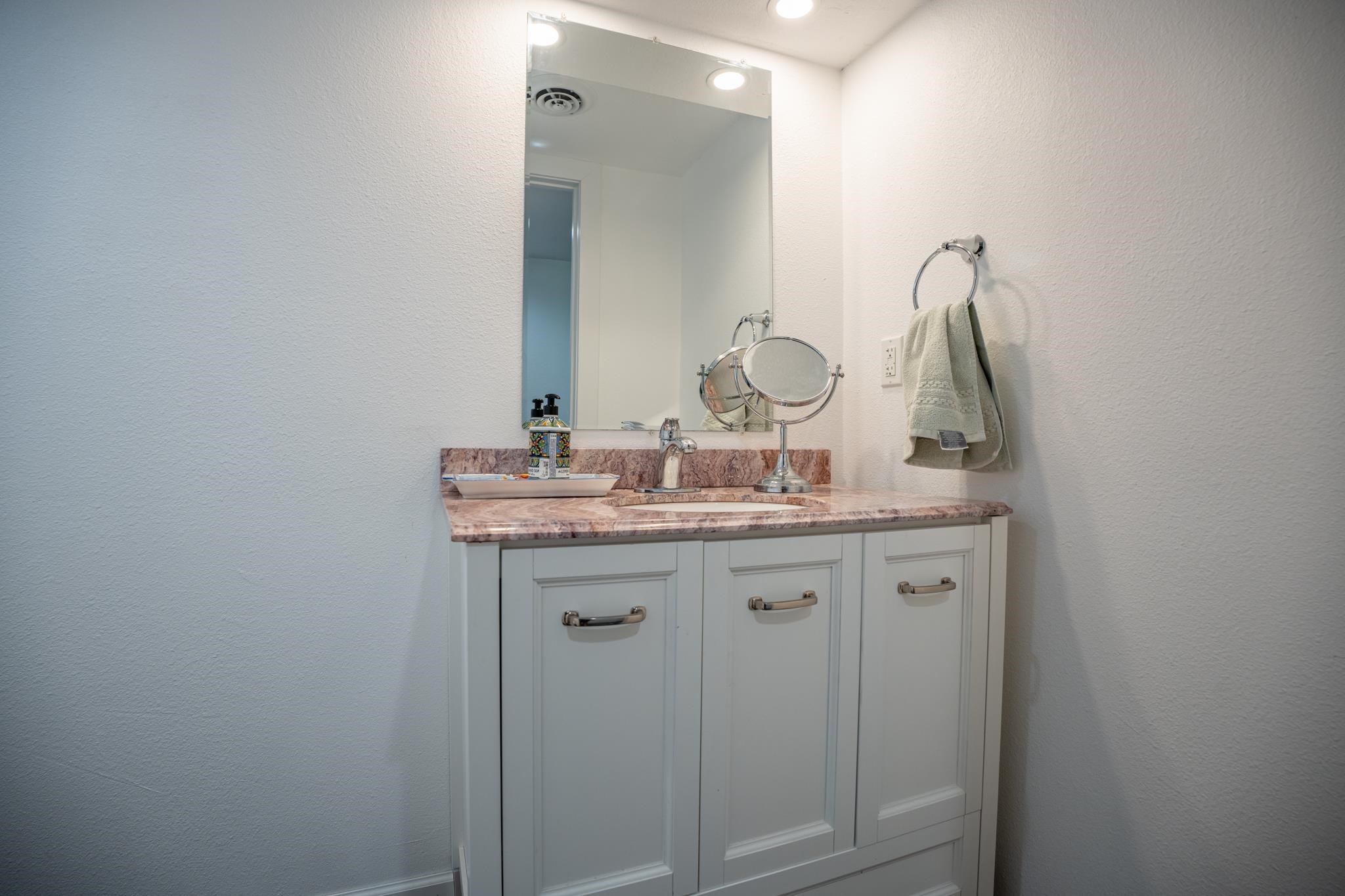 5968 East Bradley Road Byron, IL 61010 - Photo 17 of 40 a bathroom with a granite countertop sink and a mirror