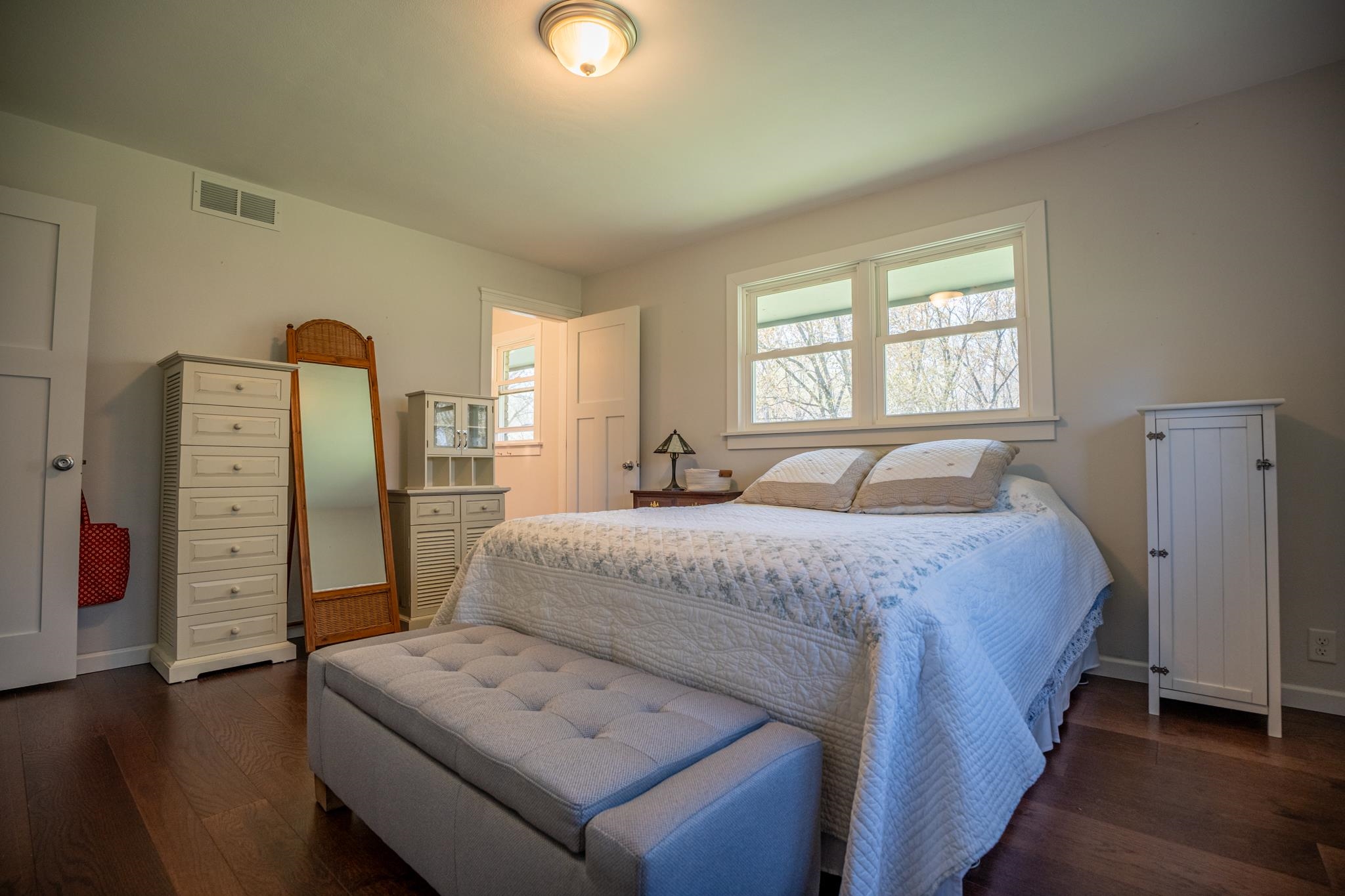 5968 East Bradley Road Byron, IL 61010 - Photo 19 of 40 a spacious bedroom with a bed and wooden floor