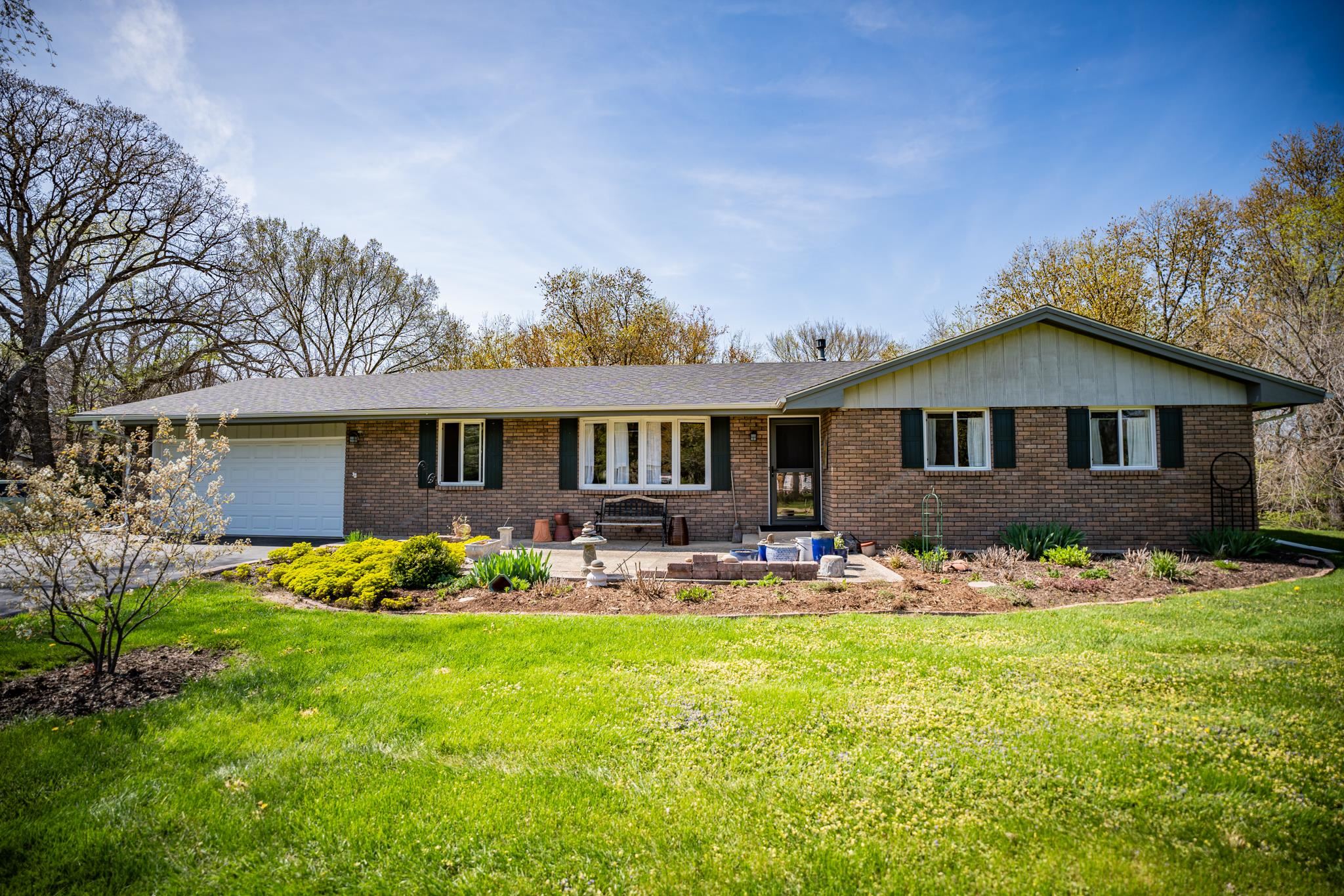 5968 East Bradley Road Byron, IL 61010 - Photo 2 of 40 a front view of a house with garden