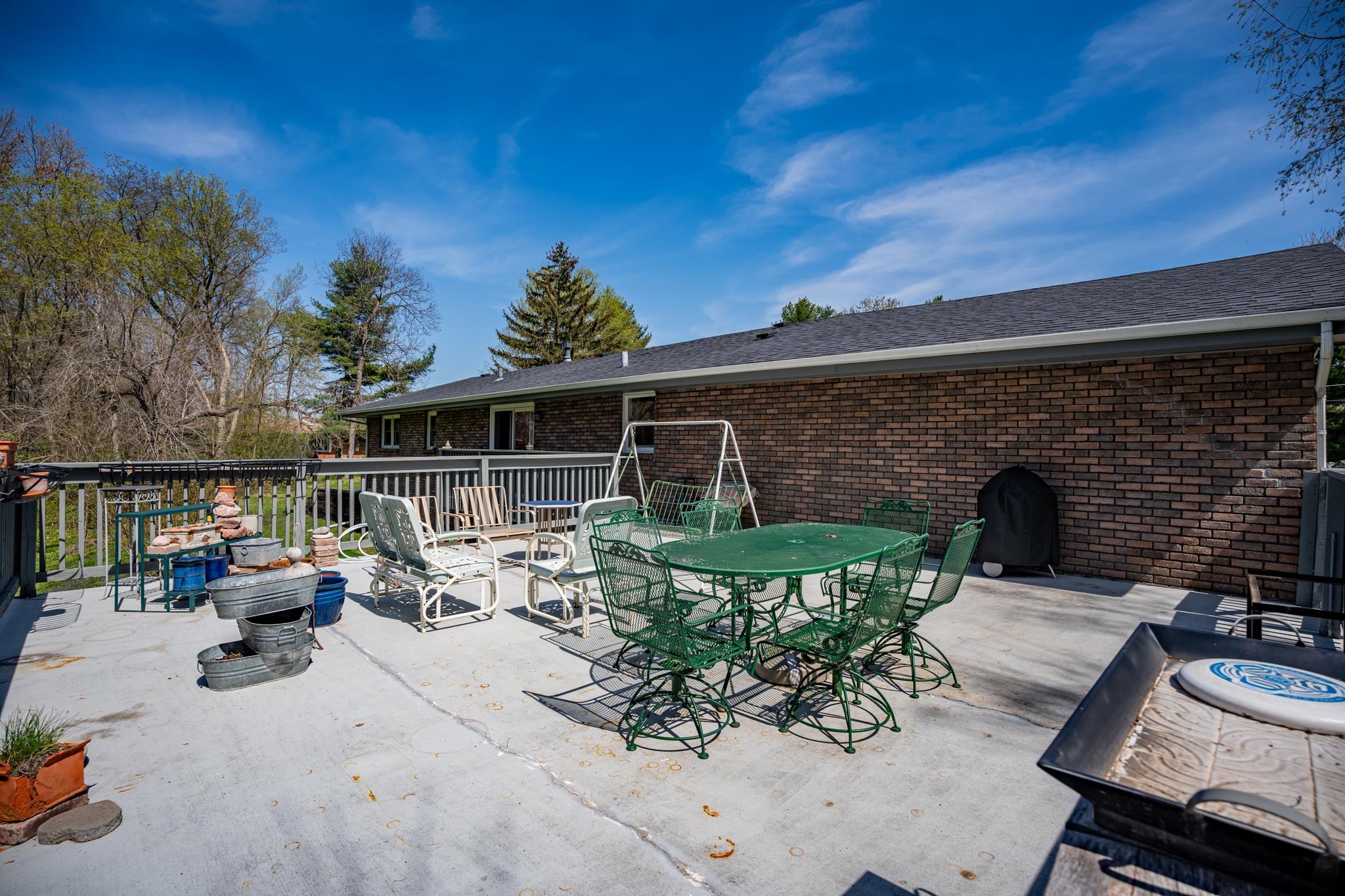 5968 East Bradley Road Byron, IL 61010 - Photo 28 of 40 a view of a patio with couches chairs and potted plants