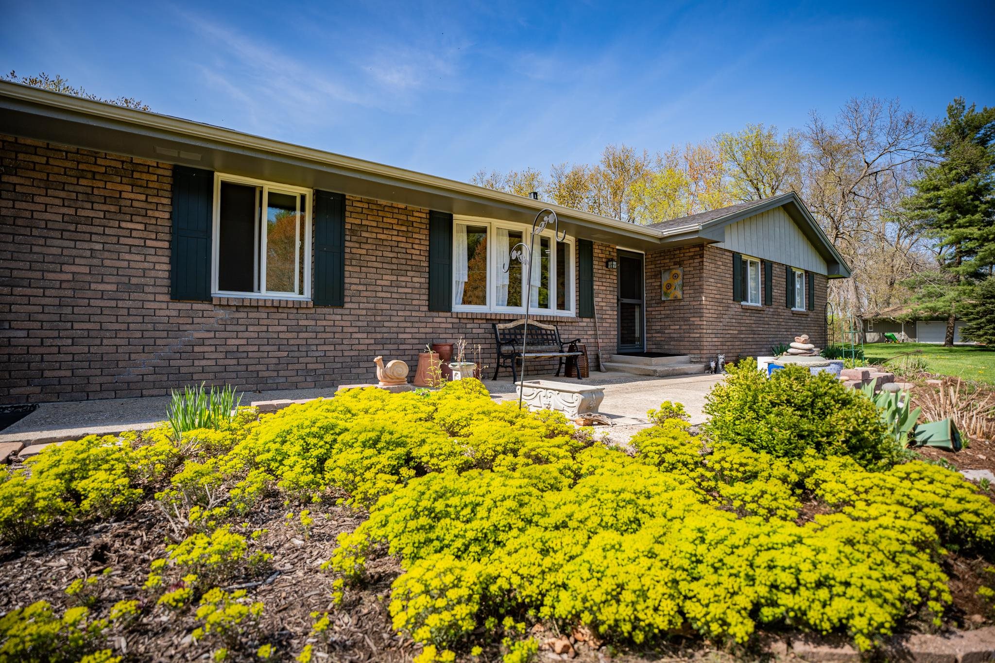 5968 East Bradley Road Byron, IL 61010 - Photo 5 of 40 a front view of a house with a yard