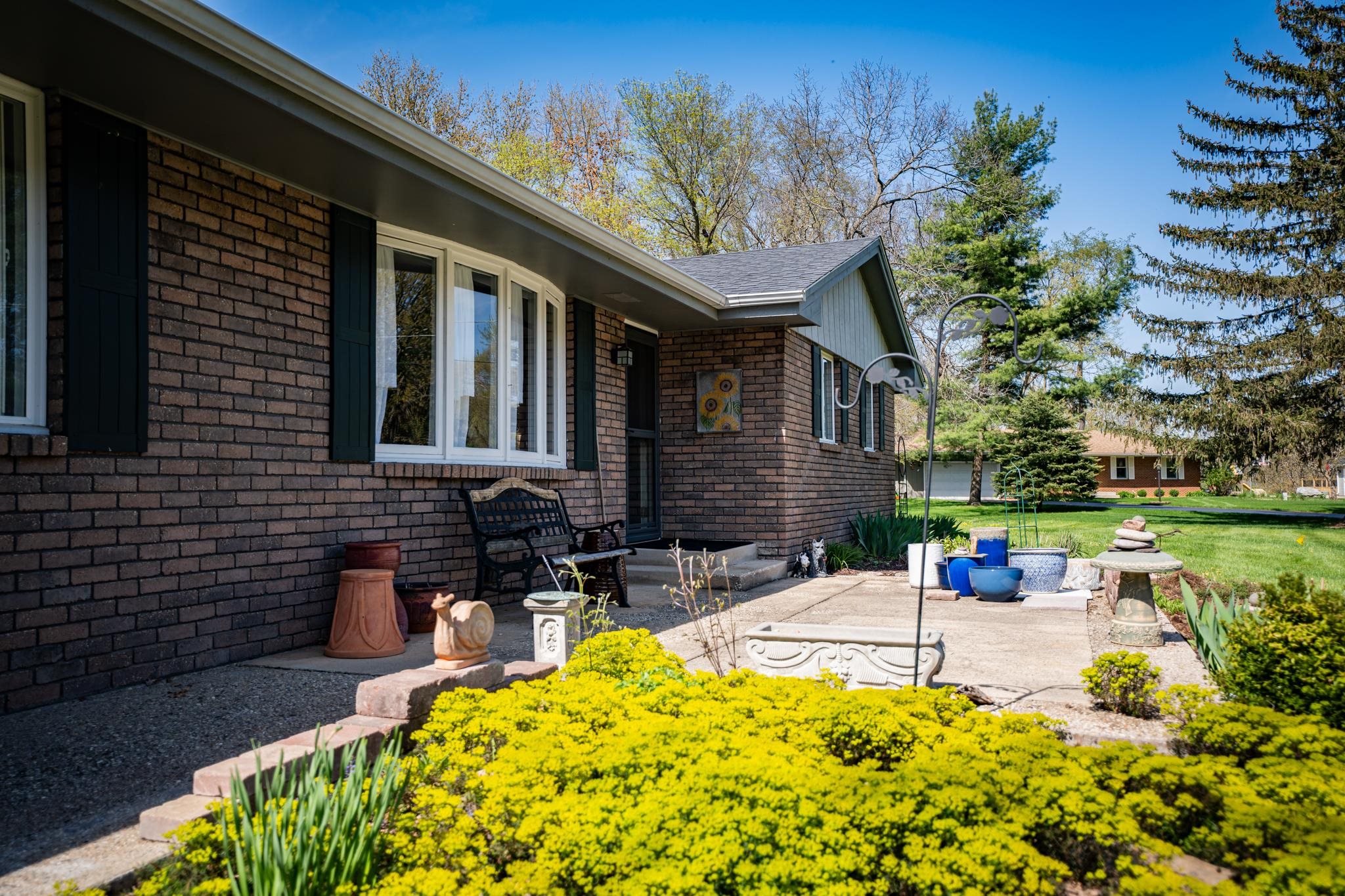 5968 East Bradley Road Byron, IL 61010 - Photo 6 of 40 a front view of a house with swimming pool garden view and a garden