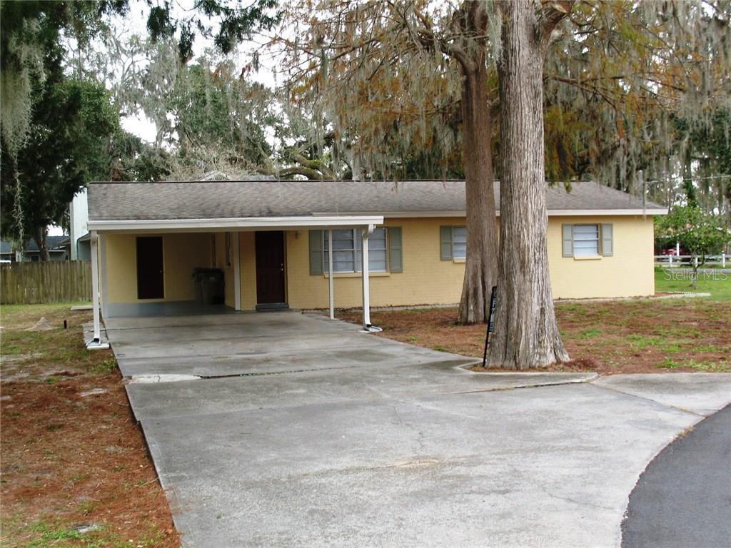 30740 Cove Road Tavares, FL 32778 - Photo 1 of 1 front view of a house with a tree