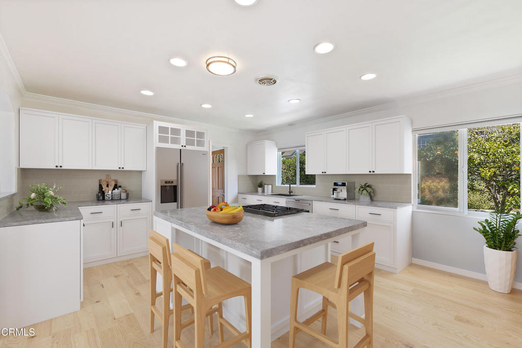 2335 Whitney Avenue Summerland, CA 93067 - Photo 12 of 33 a kitchen with a sink a counter and chairs