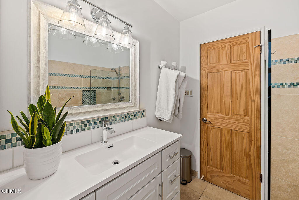 2335 Whitney Avenue Summerland, CA 93067 - Photo 23 of 33 a bathroom with a sink a mirror and a potted plant